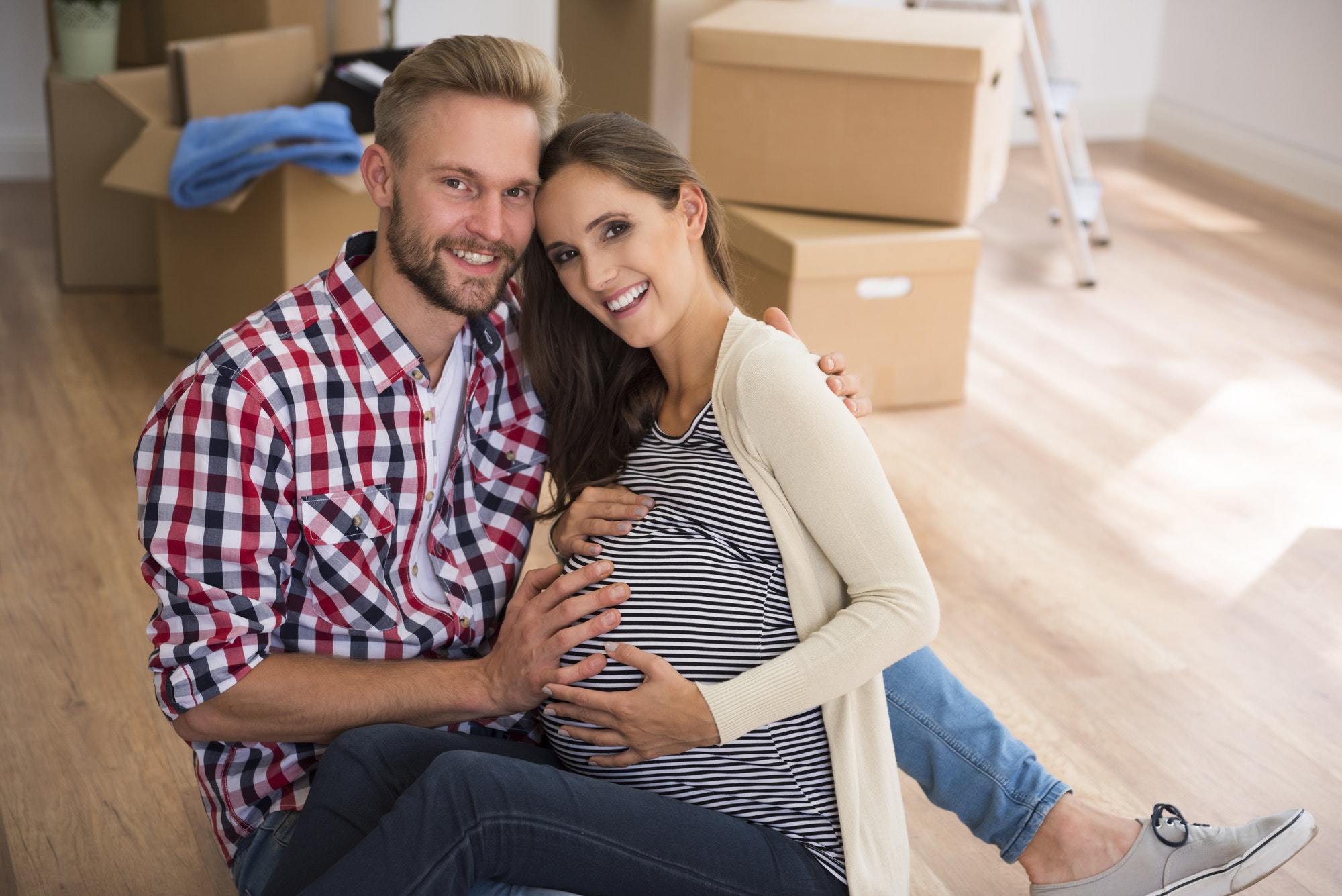 Cheerful couple in very advanced pregnancy